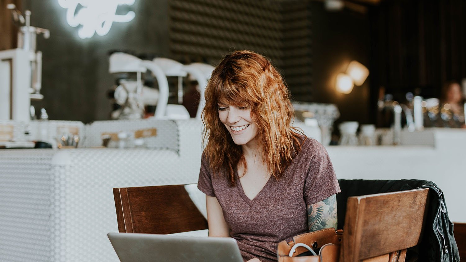 Woman sitting in a cafe with her laptop